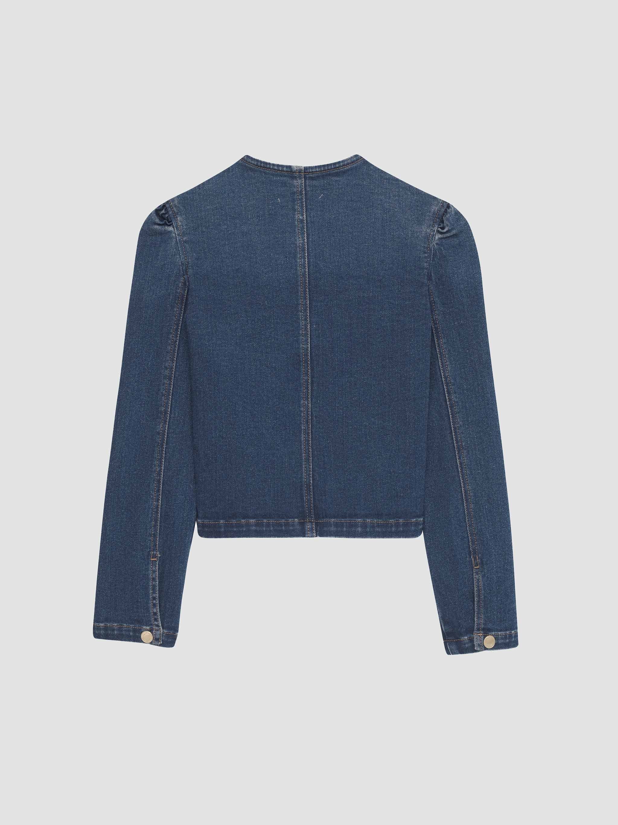 Blue denim jacket on a light gray background