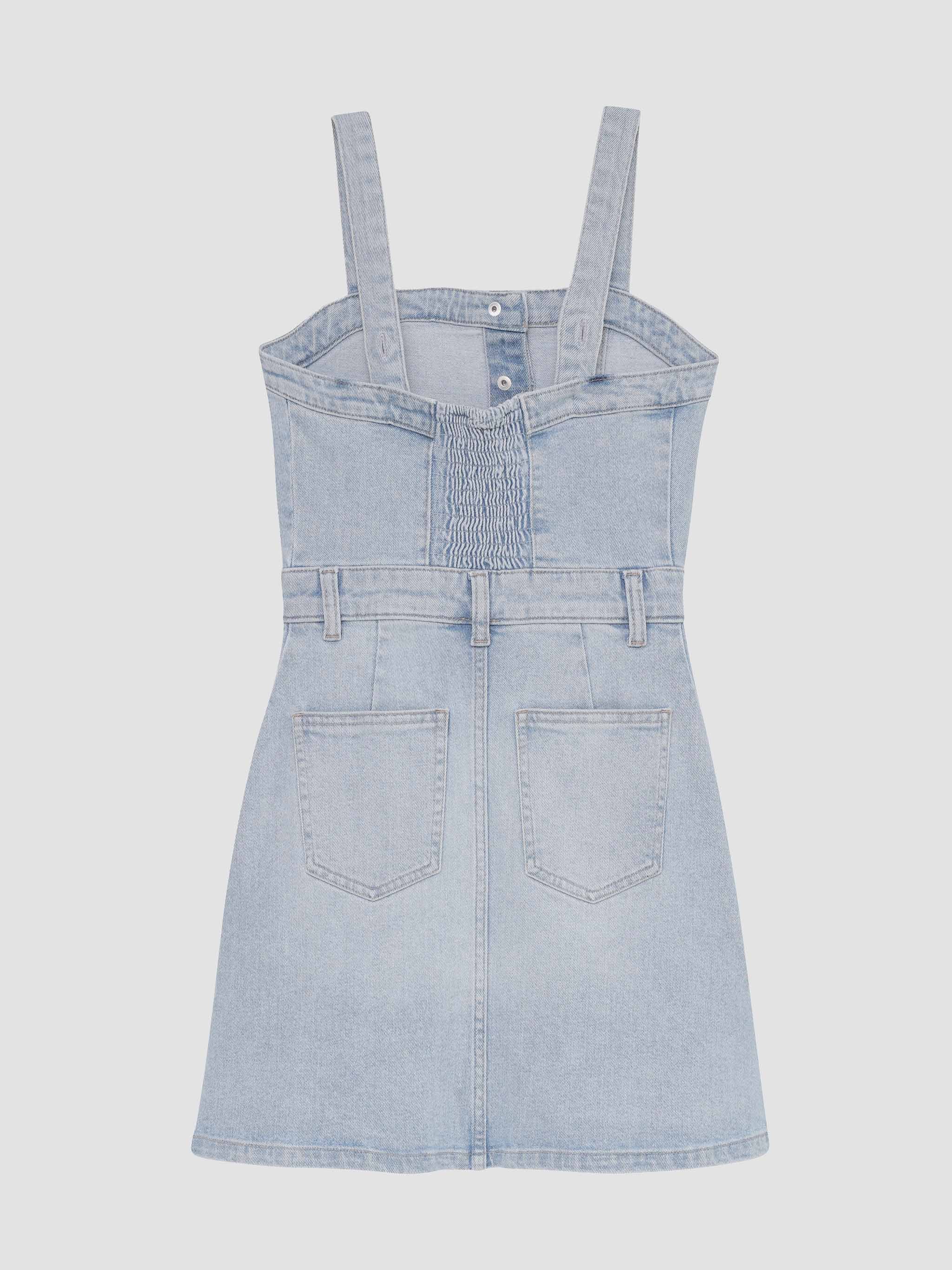 Light blue denim pinafore dress on a white background
