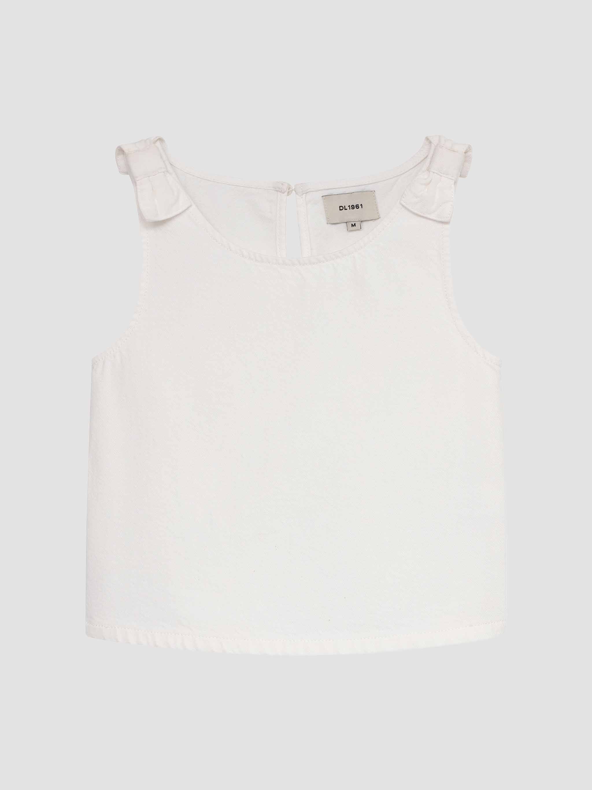 White top with ruffled shoulders on a light gray background
