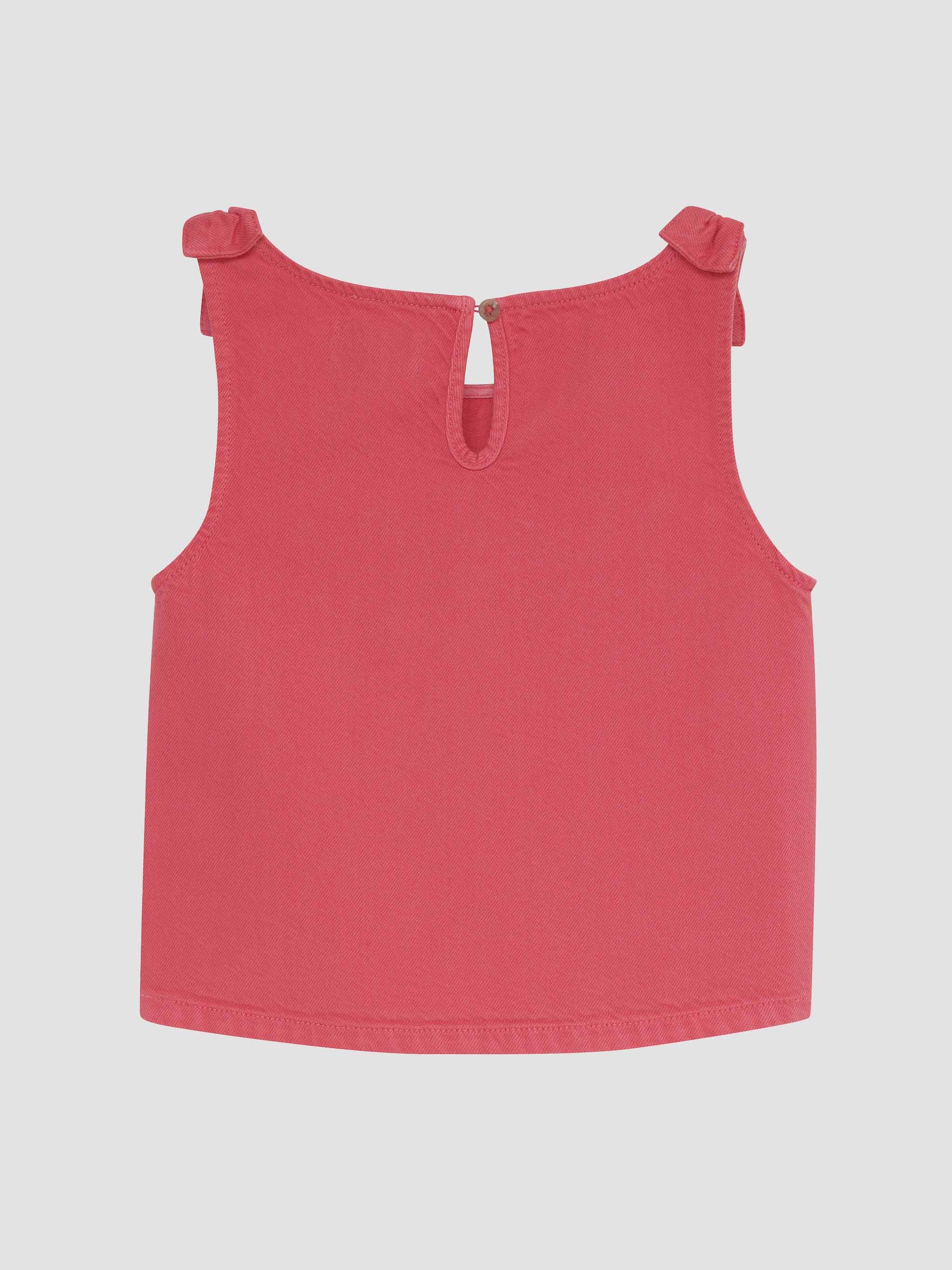 Red sleeveless top with bow details on a light gray background