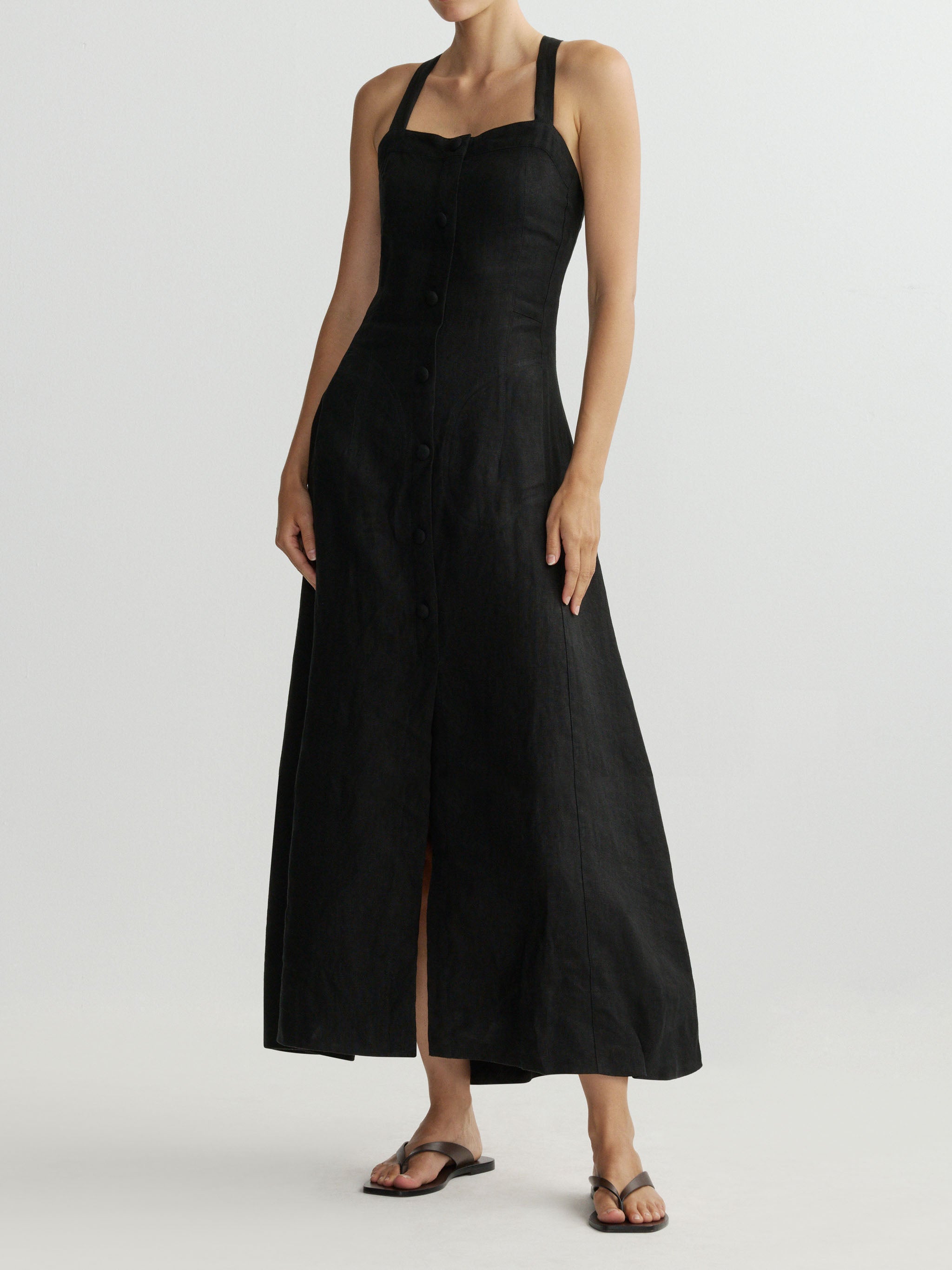 Woman wearing a black sleeveless dress on a white background