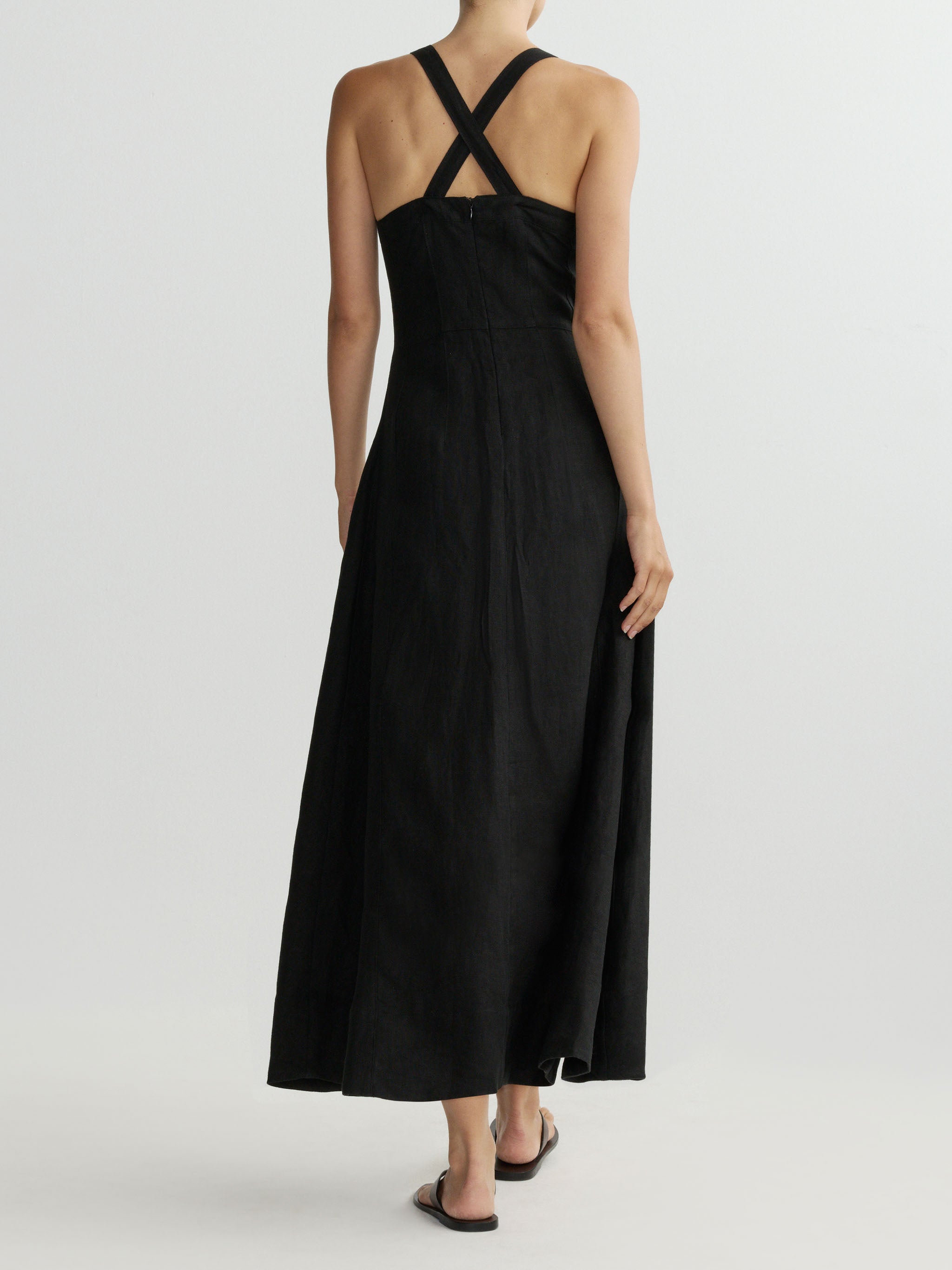 Black dress with criss-cross straps on a white background