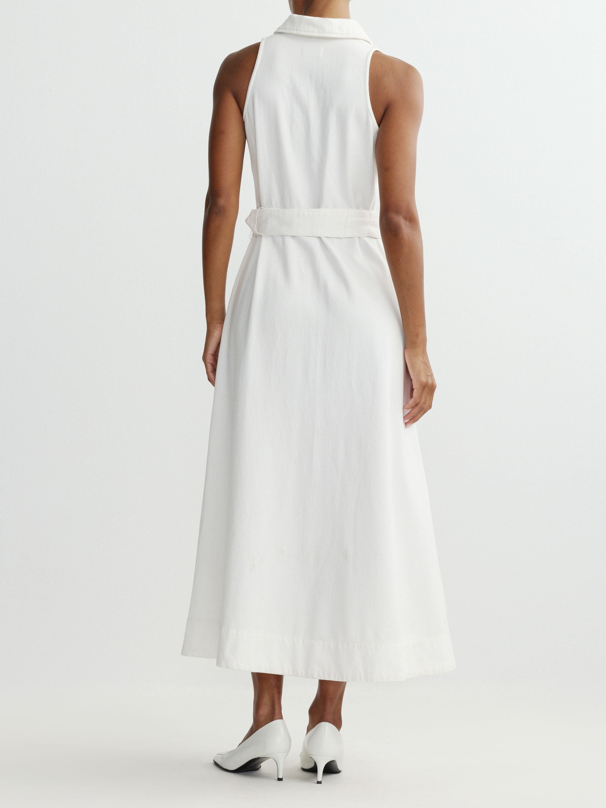 White sleeveless dress worn by a person on a white background