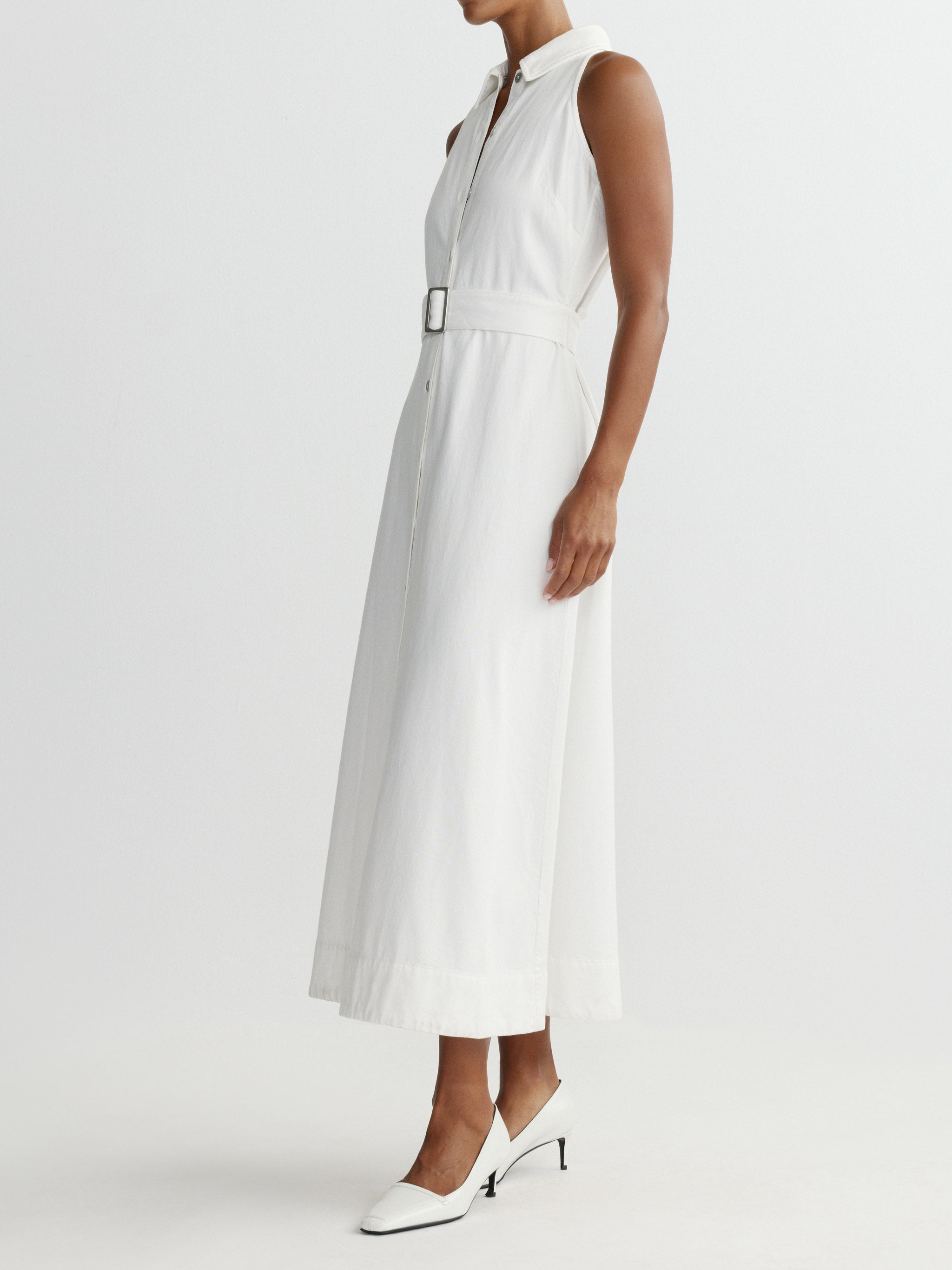 White sleeveless dress worn by a person on a white background