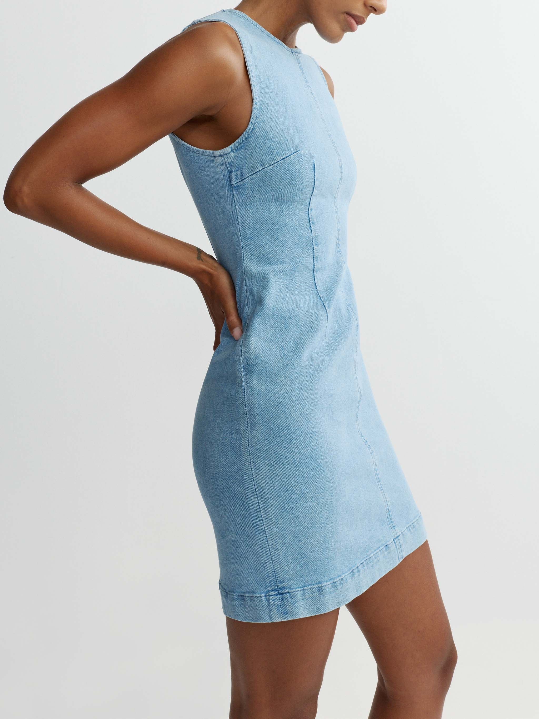 Light blue denim dress worn by a model on a white background
