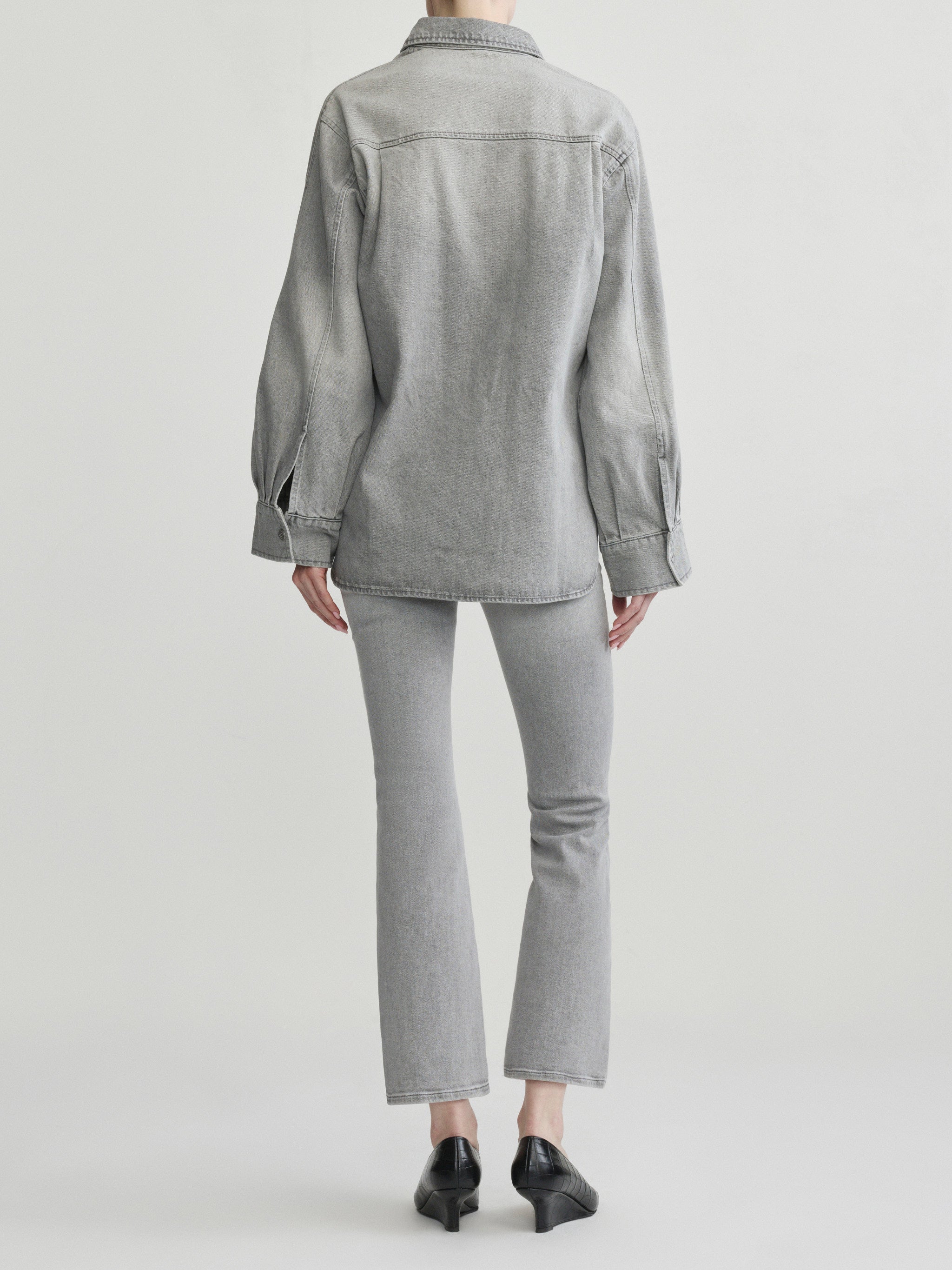 Mika Shirt in Light Smoke on a model with grey jeans, studio full-length back view.