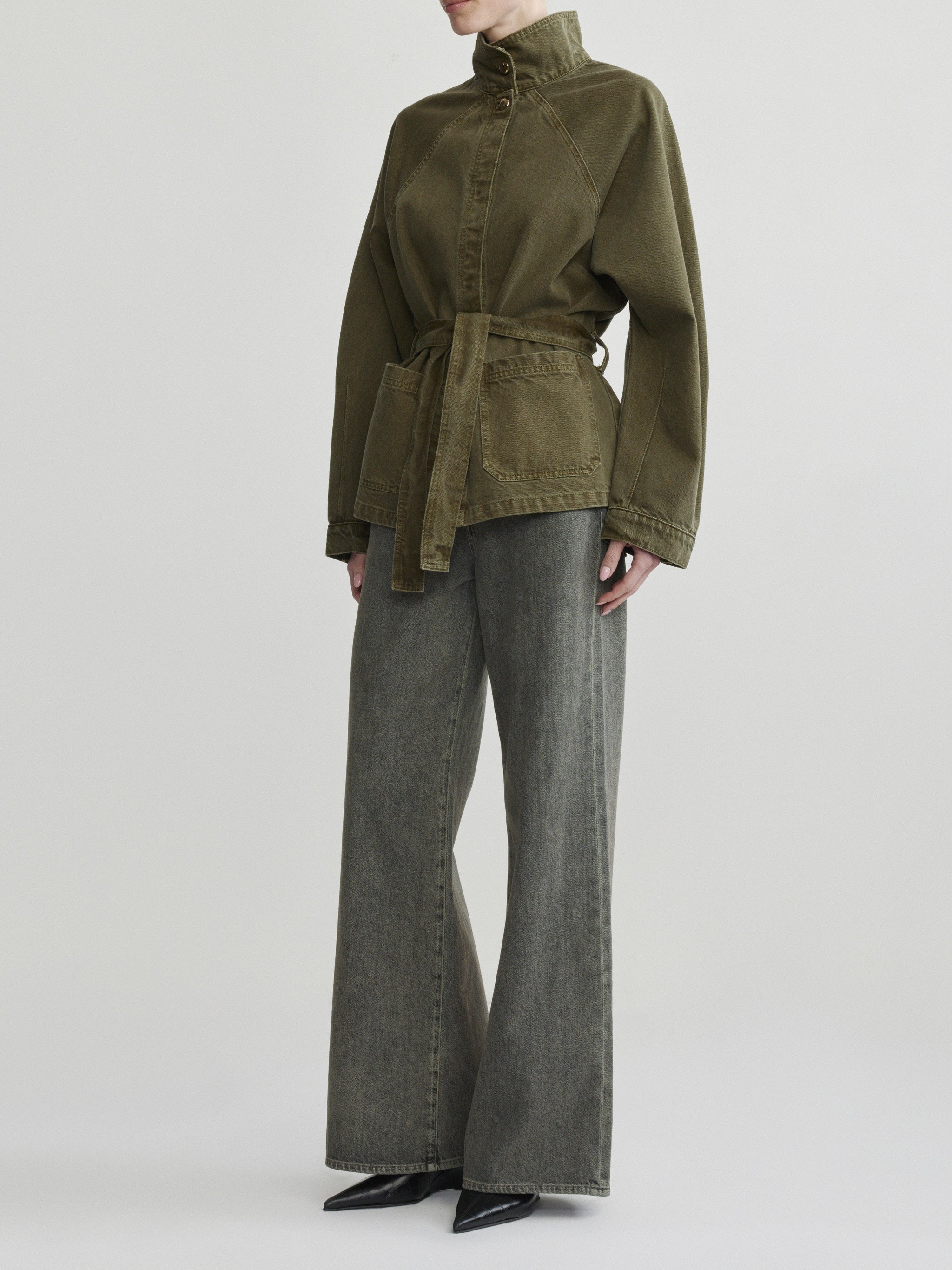Shiloh Jacket in Pine on a model with grey wide-leg jeans, studio full-length angled view.