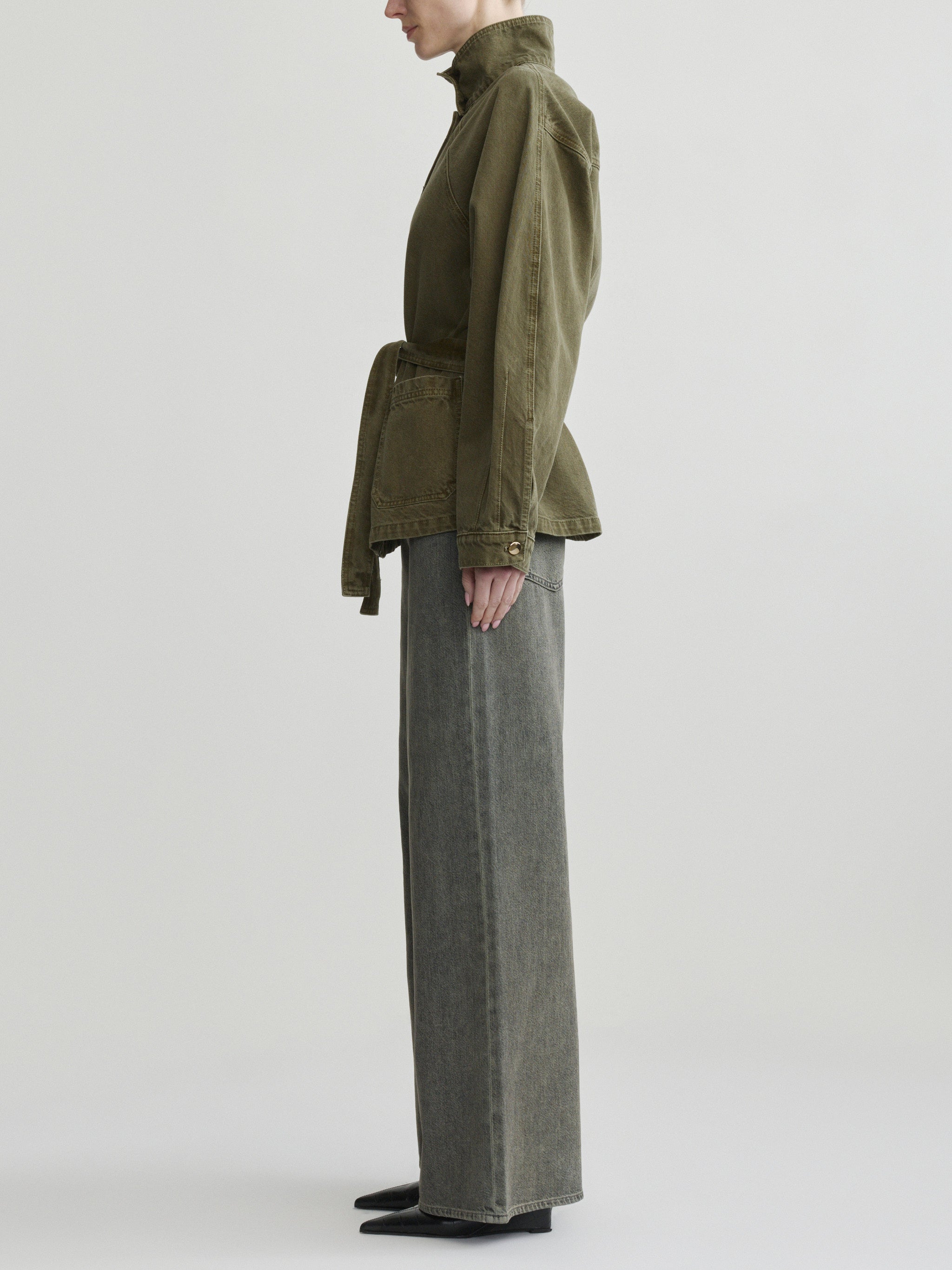 Shiloh Jacket in Pine on a model with grey jeans, studio full-length side profile view.