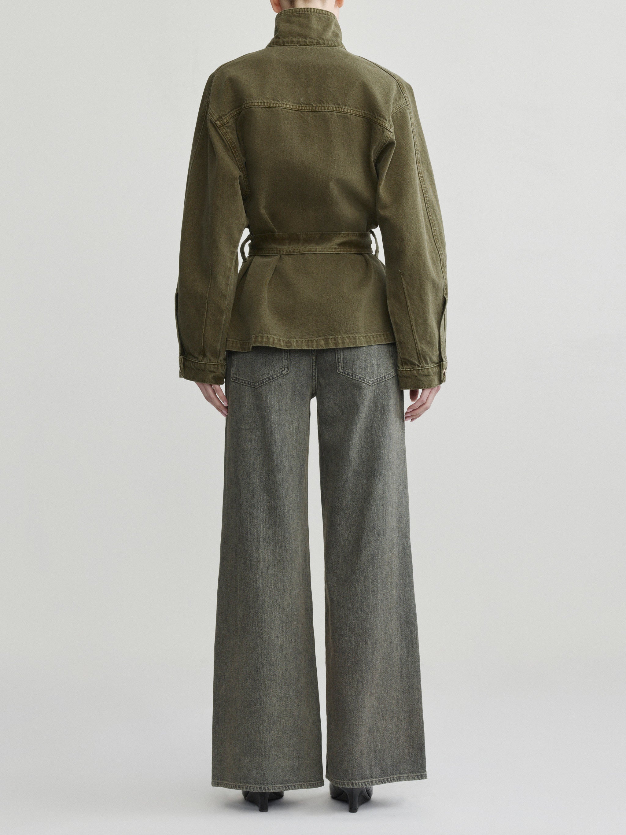 Shiloh Jacket in Pine on a model with grey wide-leg jeans, studio full-length back view.