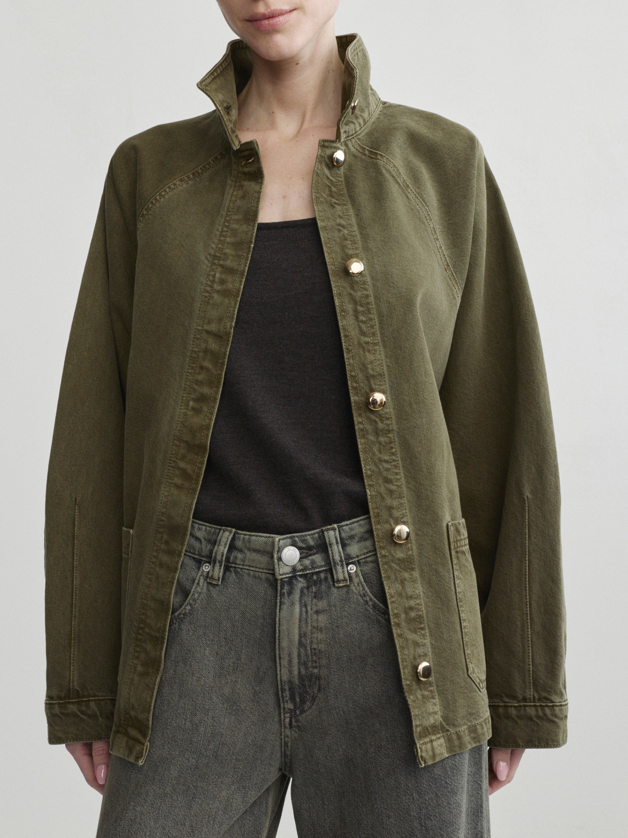 Shiloh Jacket in Pine over a black tank on a model, studio portrait crop, open front.