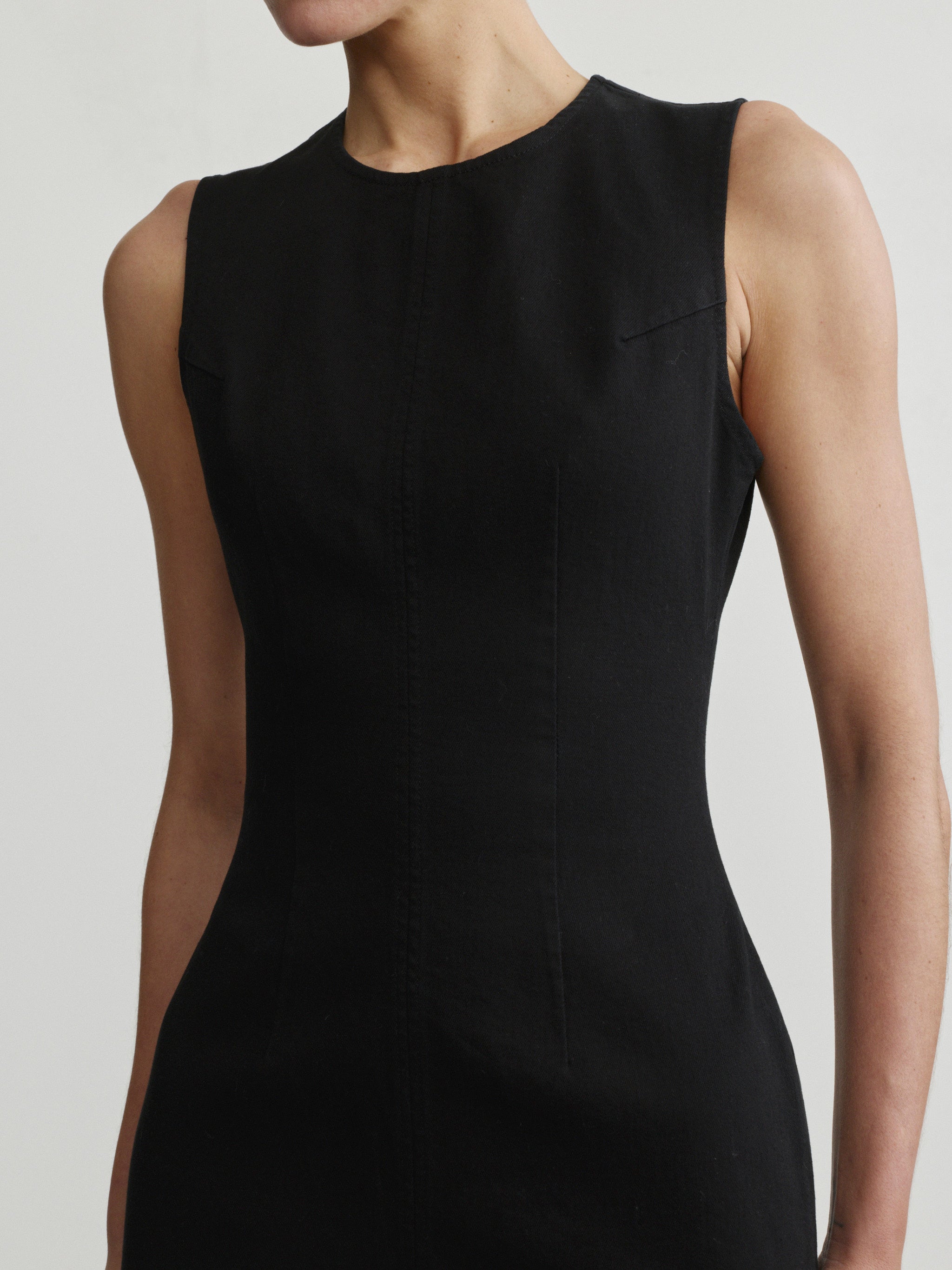 Esme Dress in Black on a model, studio portrait crop of neckline and fitted bodice.