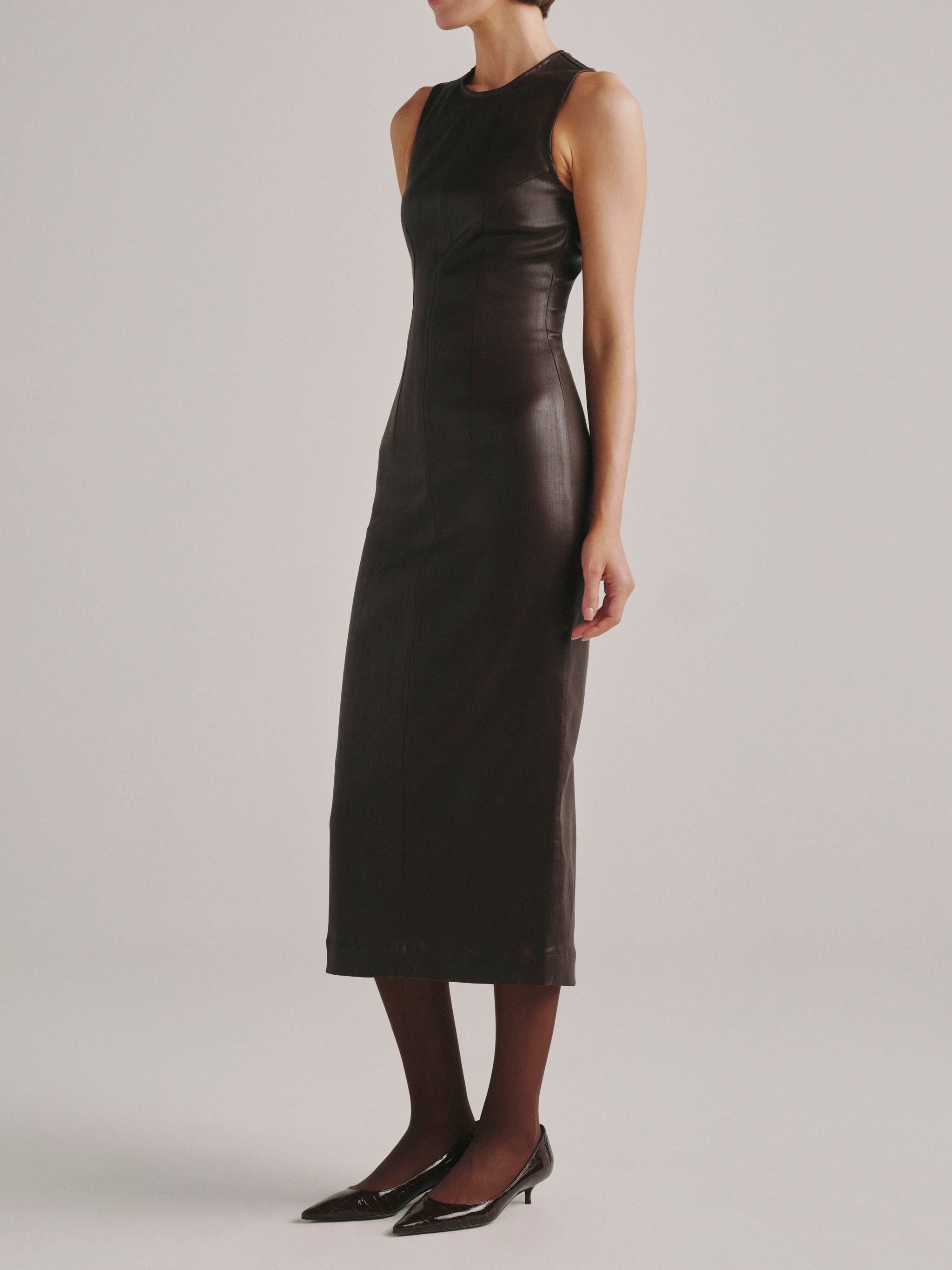 DL1961 Esme Midi Denim Dress in dark berry coated denim, sleeveless fitted midi, angled side view.