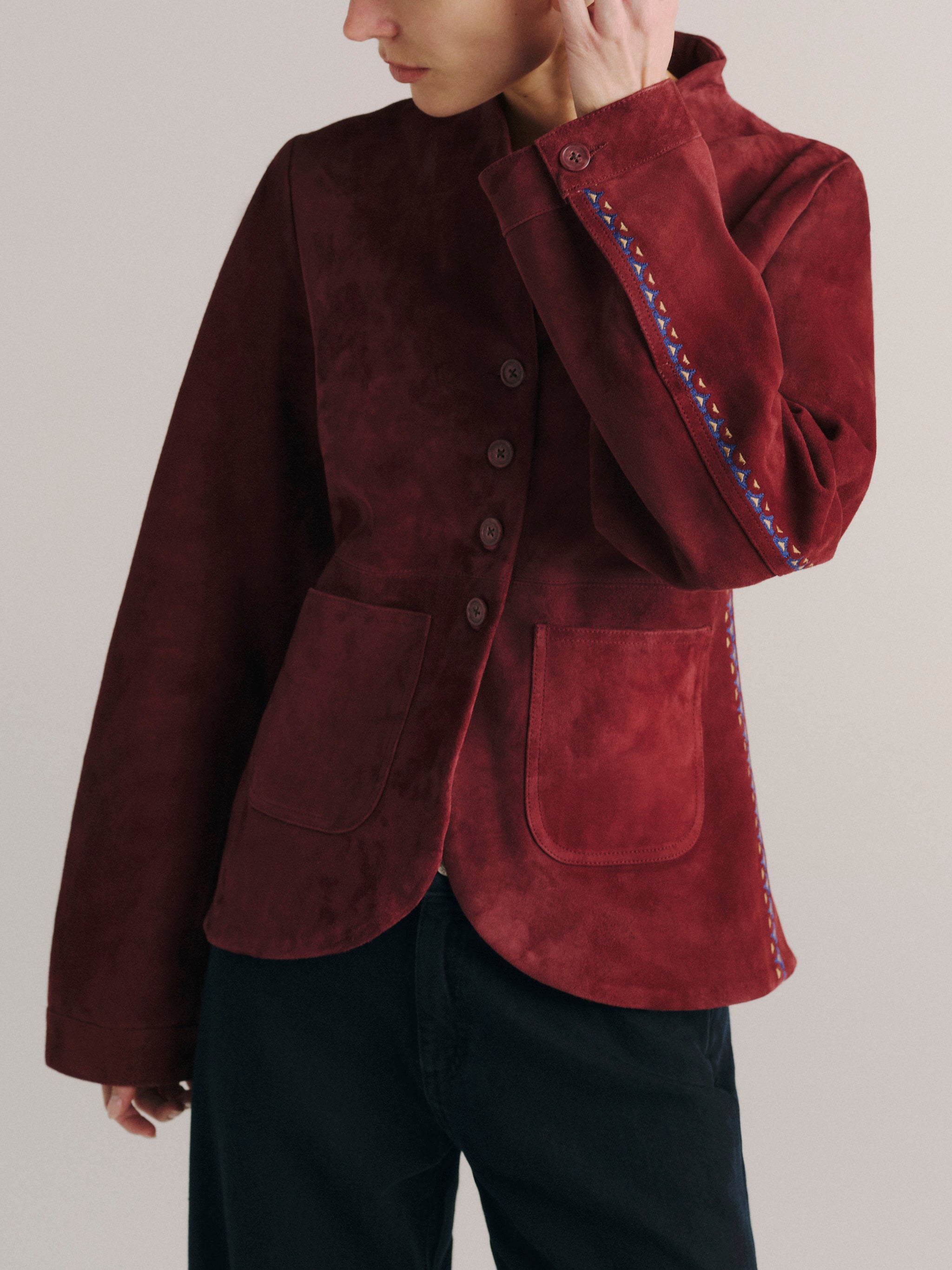 DL1961 women's Telluride suede jacket in 'Burgundy Suede Embroidery', angled front view showing the embroidered sleeve and patch pocket.