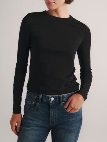 DL1961 Shrunken Tee long-sleeve in black, a fitted crew-neck knit top, worn with blue jeans, front view.