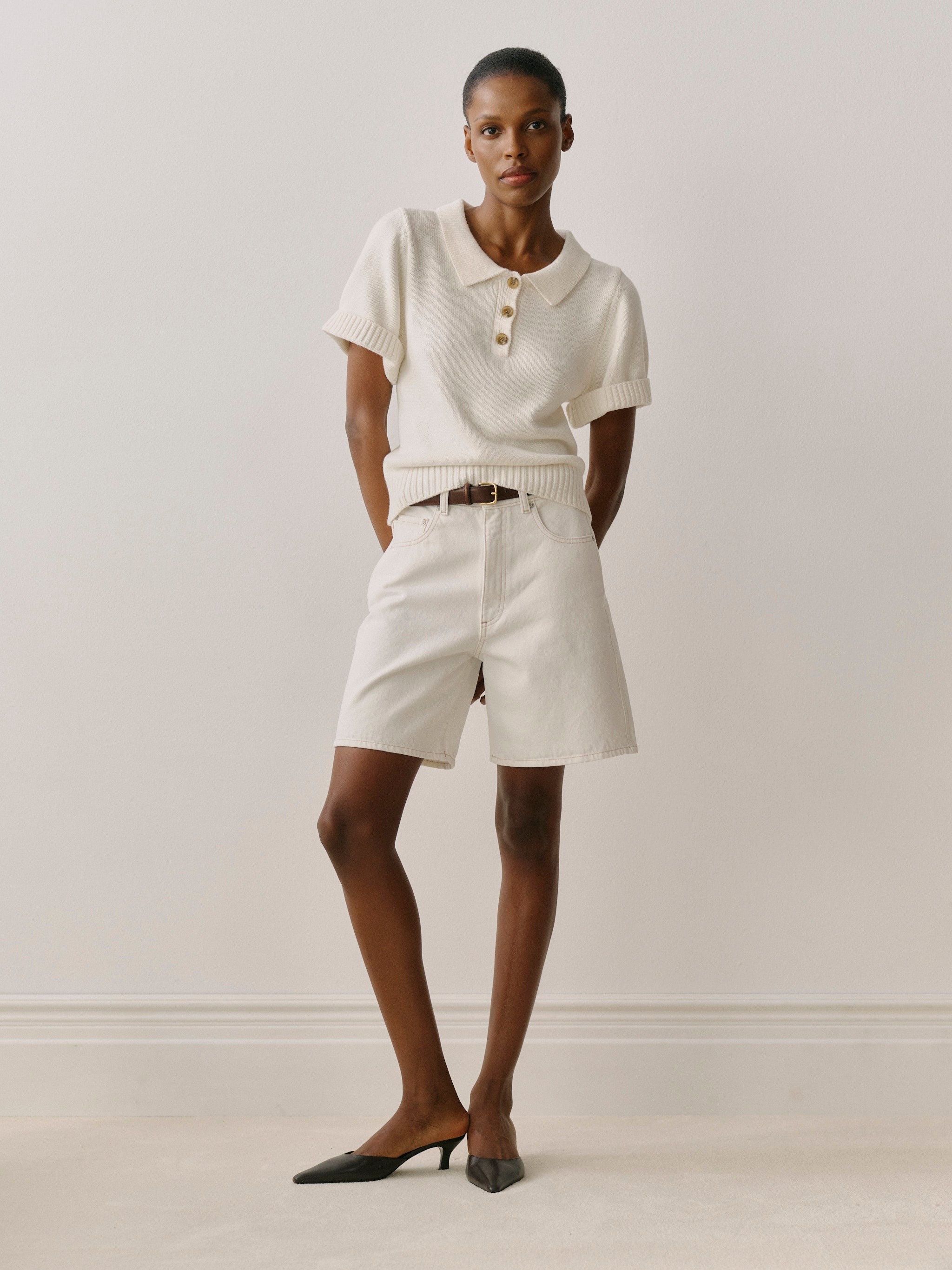 Woman wearing a white outfit with a plain background