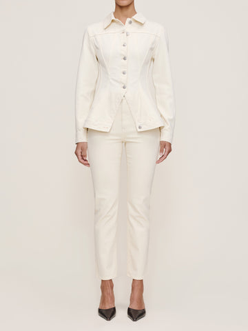 Person wearing a white suit on a plain background