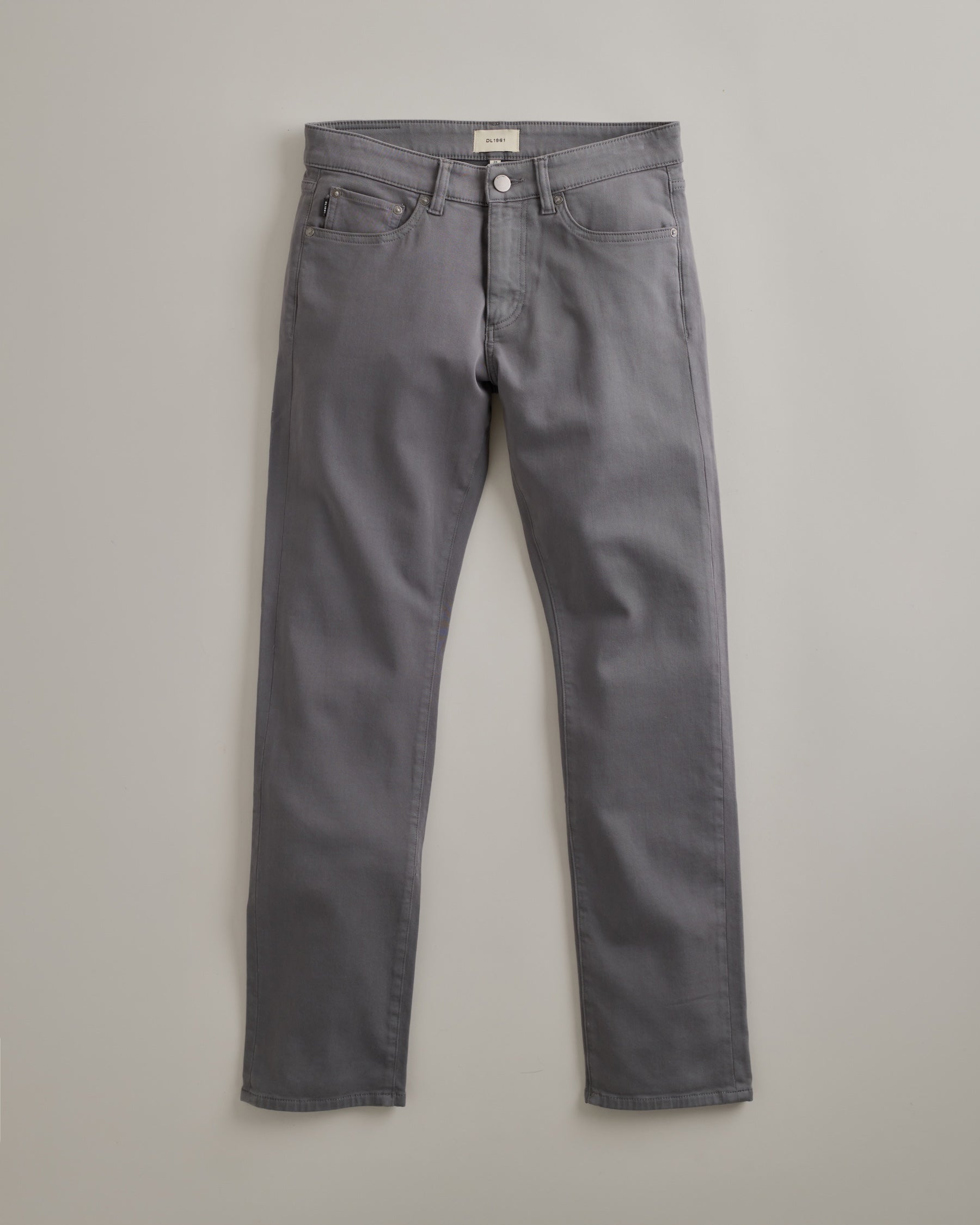 DL1961 men's Nick Slim Jeans in 'Alloy' — studio flat lay packshot on a plain background, no model.