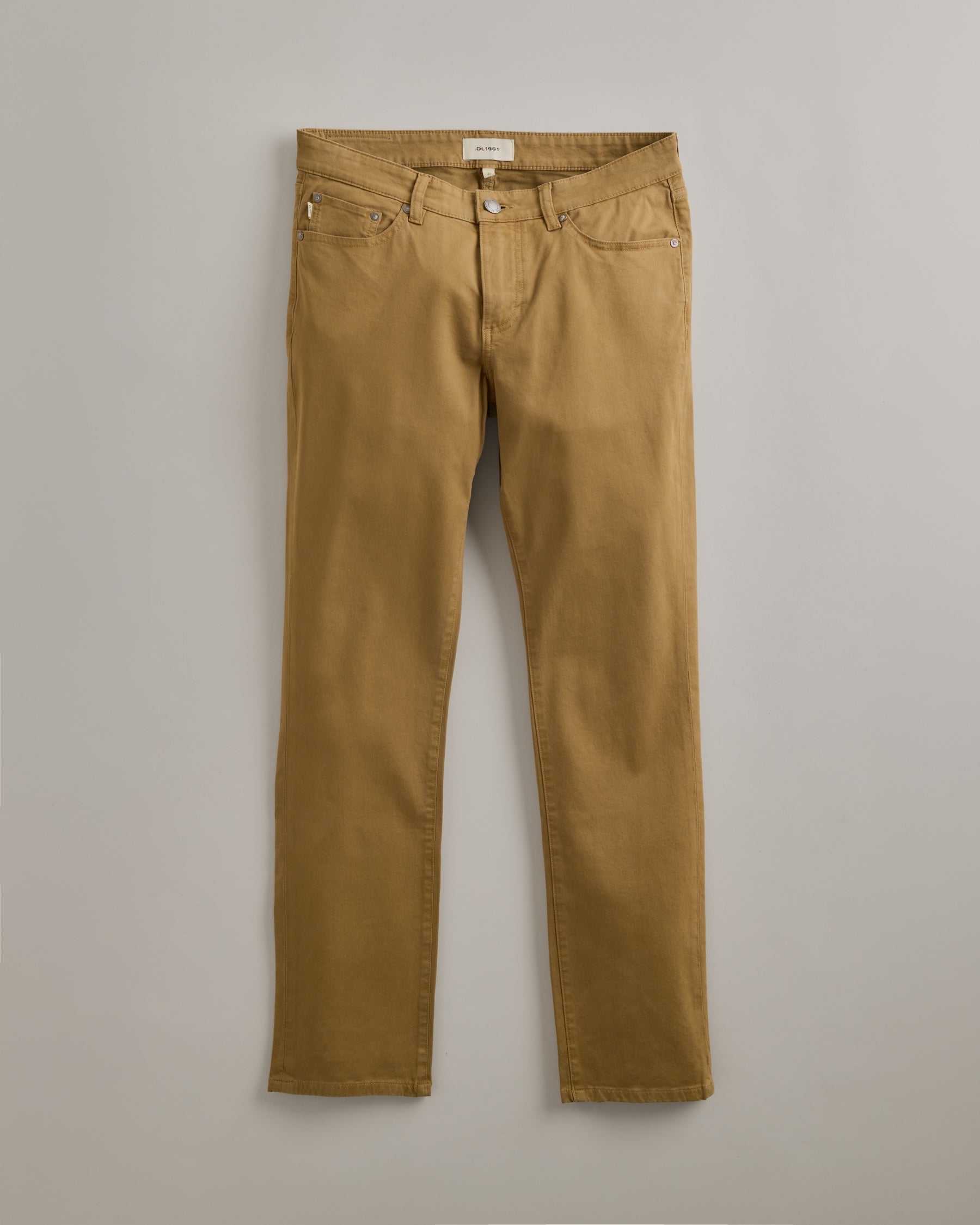 DL1961 men's Nick Slim Pants in 'Brass' — studio flat lay packshot on a plain background, no model.