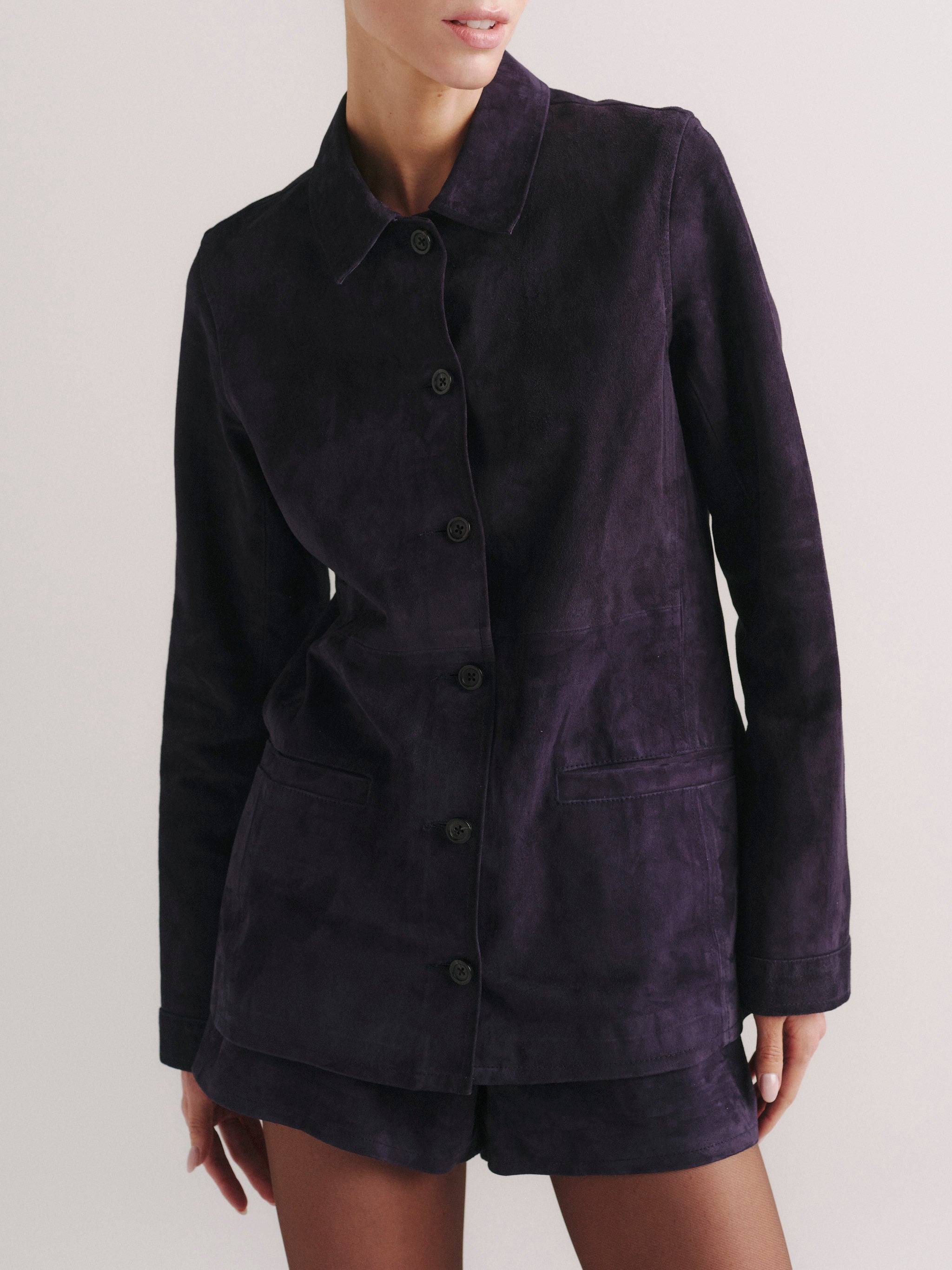 DL1961 Maria Suede Jacket in plum purple suede, fitted button-front, worn with matching suede shorts, front.