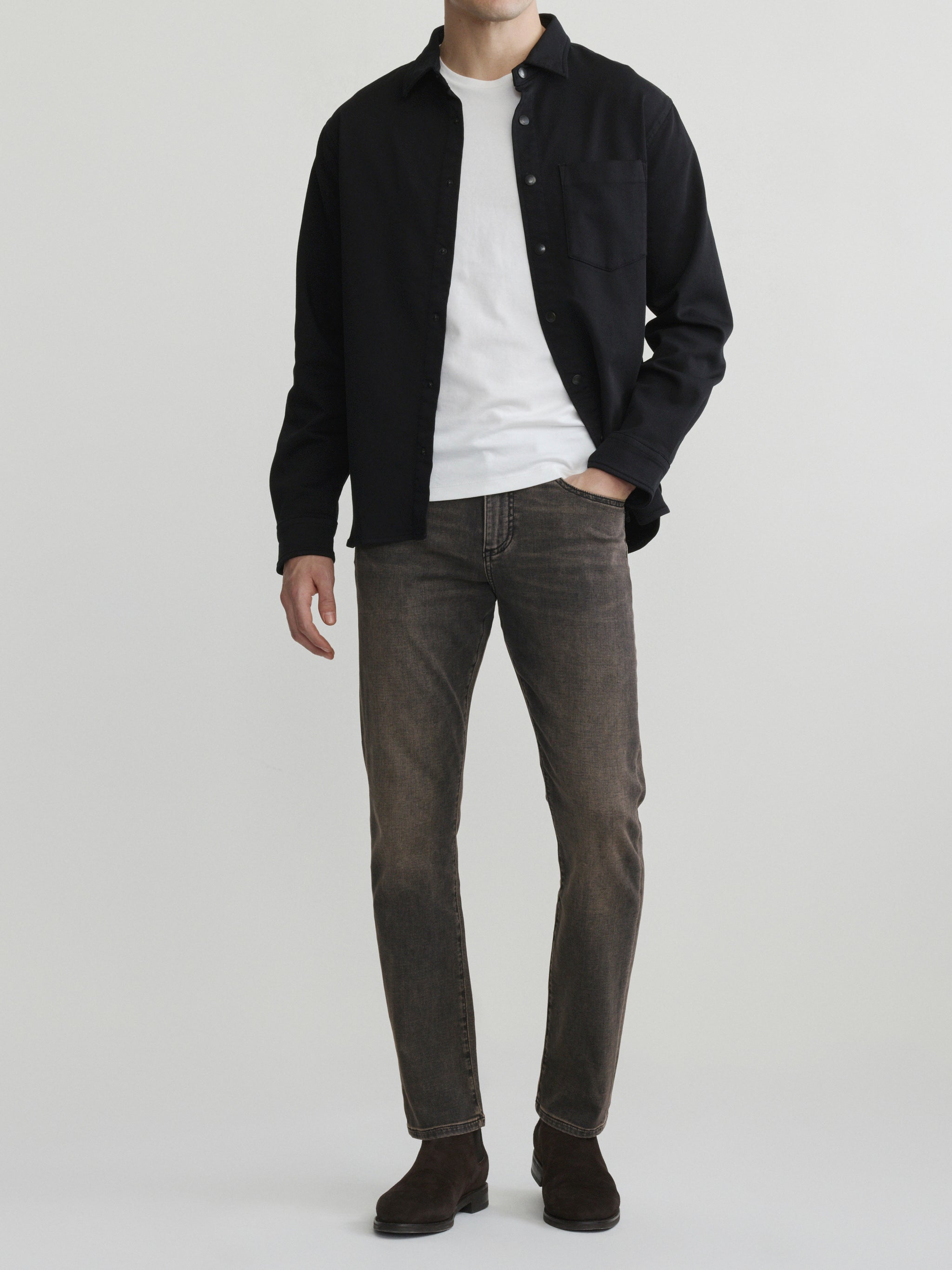 DL1961 men's Russell slim-straight jeans in washed grey-brown 'Rock', full-length front with black overshirt and white tee